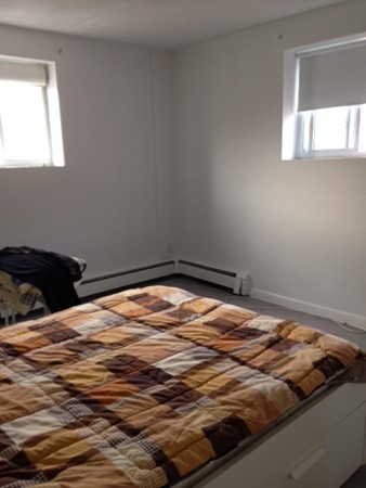 38 Westgate Road, Unit 5 Boston, MA 02467 - Photo 7 of 10 a bedroom with a bed and a window
