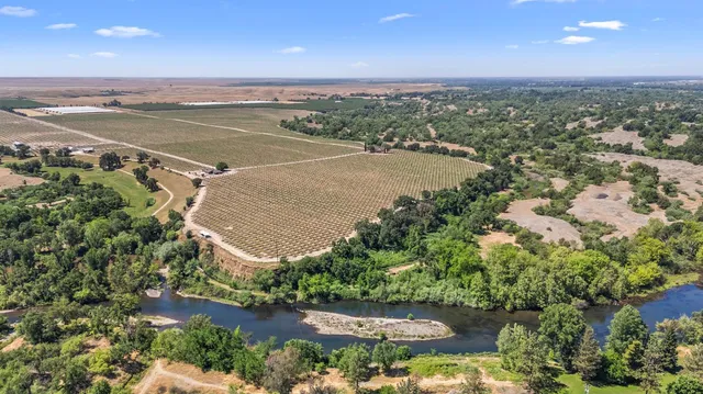 an aerial view of a houses with a yard
