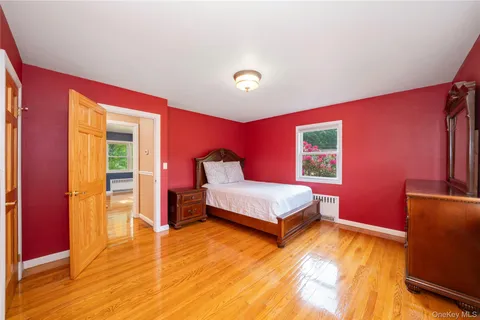 a spacious bedroom with a bed and a dresser