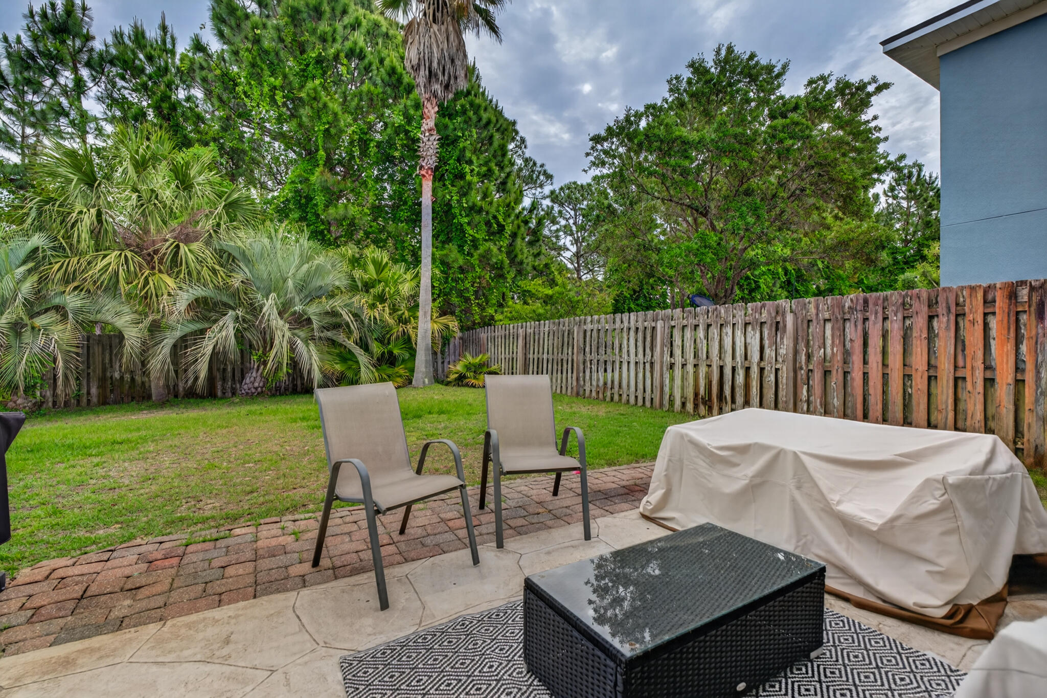 268 Loblolly Bay Drive Santa Rosa Beach, FL 32459 - Photo 49 of 73 a view of a patio with table and chairs and potted plants