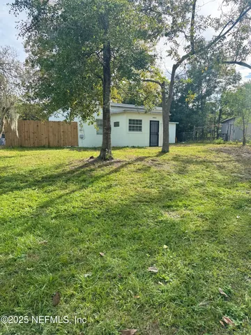 a house that has a tree in front of it