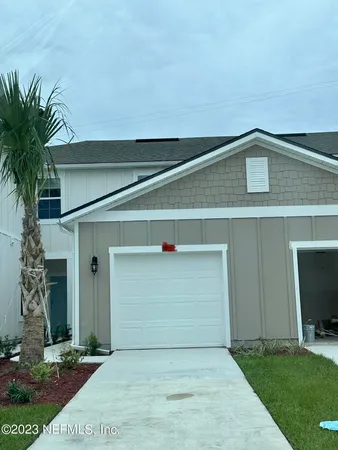 a front view of a house with garage