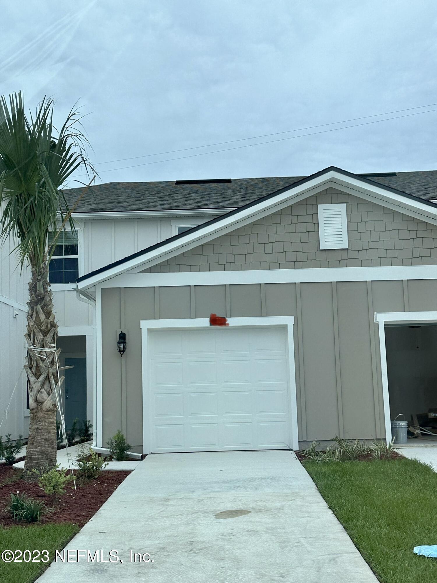 a front view of a house with garage