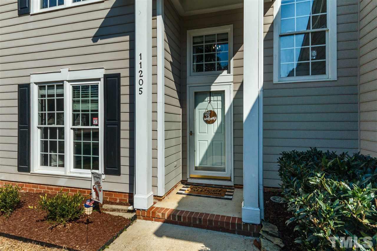 11205 North Radner Way Raleigh, NC 27613 - Photo 2 of 22 a front view of a house with a garden