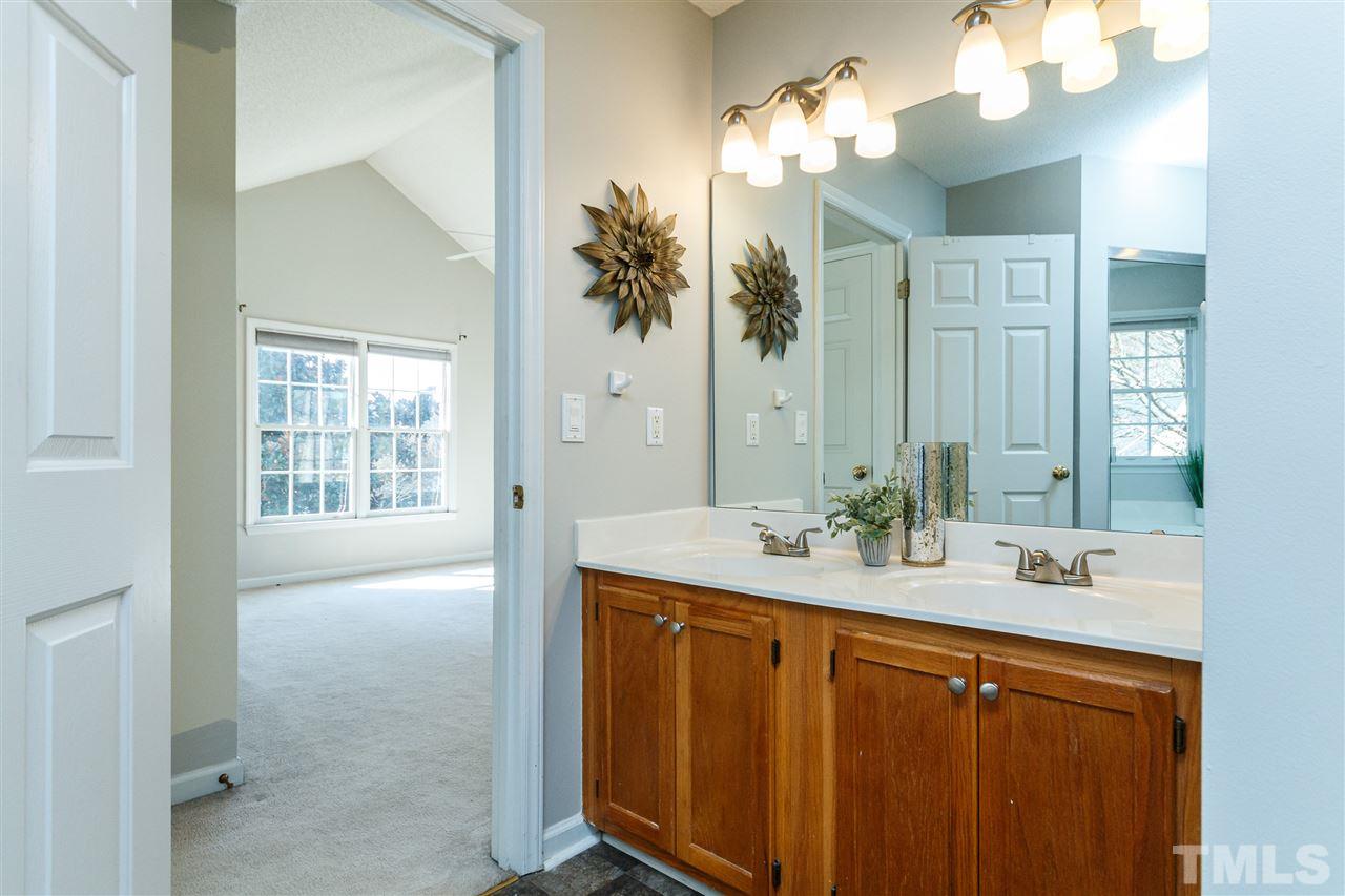 11205 North Radner Way Raleigh, NC 27613 - Photo 14 of 22 a bathroom with a sink vanity and a mirror