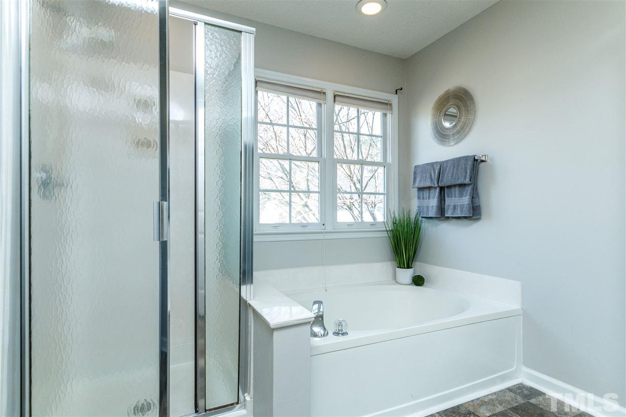 11205 North Radner Way Raleigh, NC 27613 - Photo 15 of 22 a white bath tub sitting next to a window