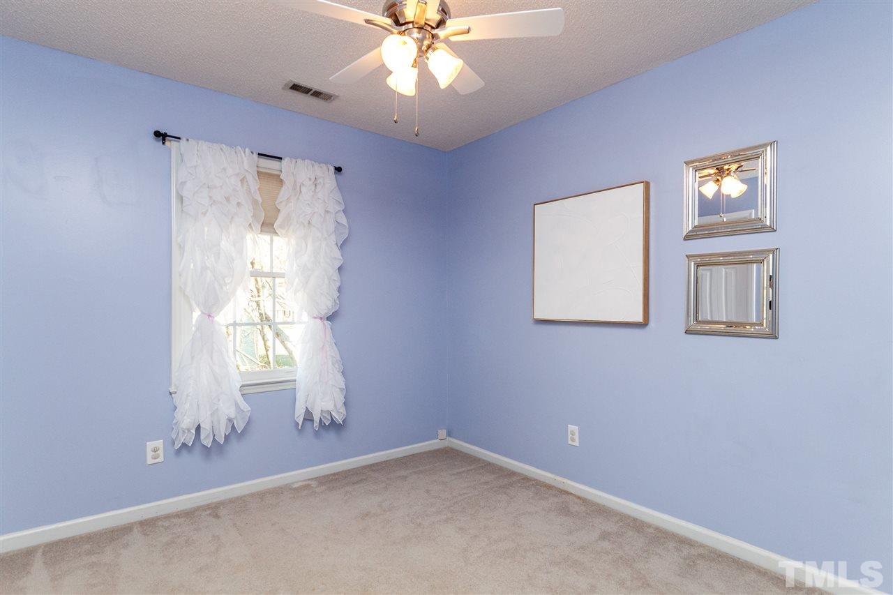 11205 North Radner Way Raleigh, NC 27613 - Photo 16 of 22 an empty room with windows and fan