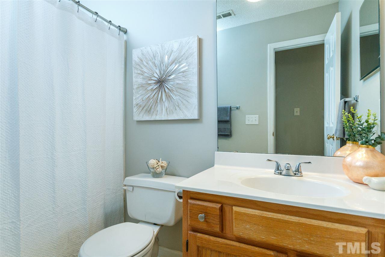 11205 North Radner Way Raleigh, NC 27613 - Photo 18 of 22 a bathroom with a sink a toilet and mirror
