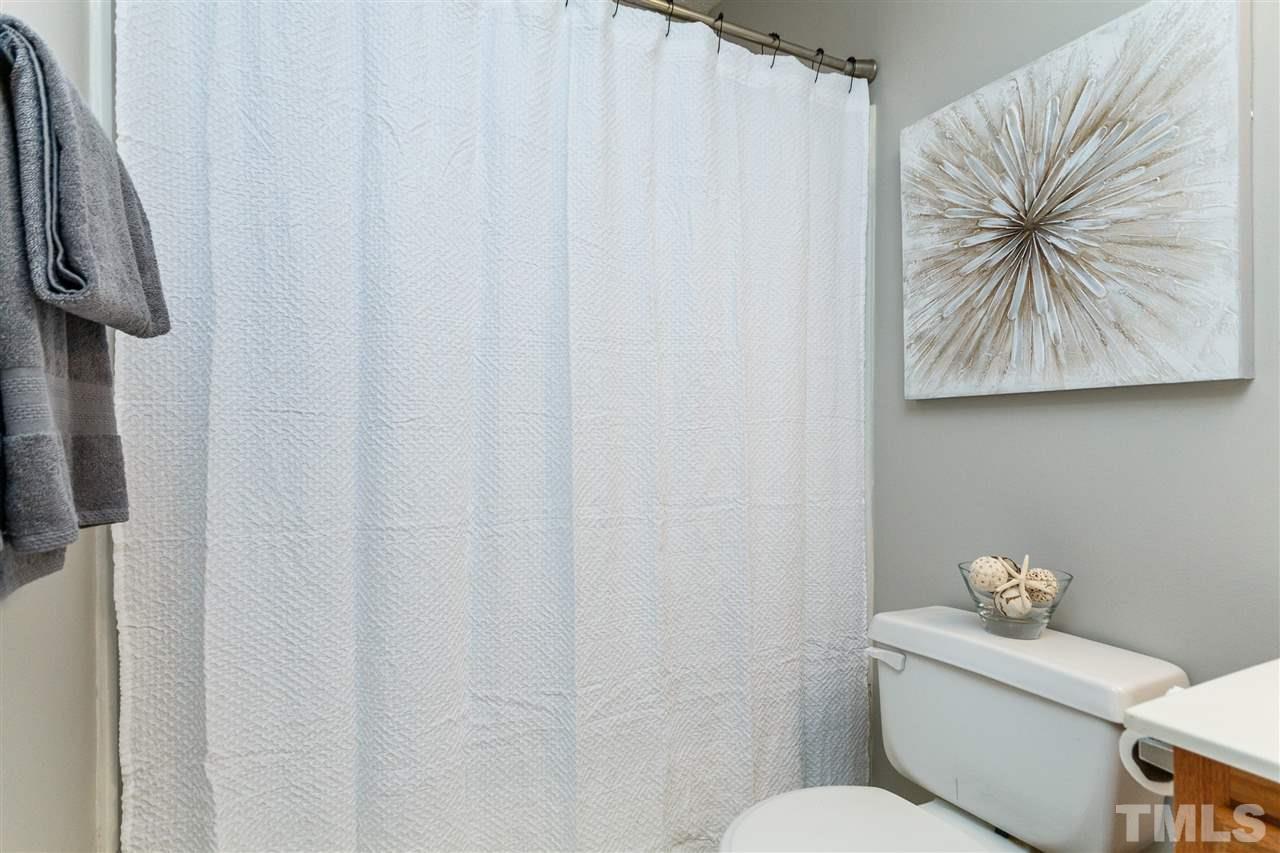 11205 North Radner Way Raleigh, NC 27613 - Photo 19 of 22 a bathroom with a toilet and a shower curtain