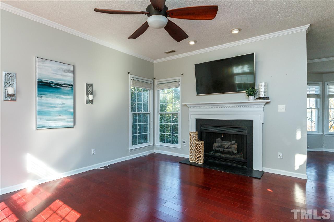 11205 North Radner Way Raleigh, NC 27613 - Photo 3 of 22 a living room with wooden floor and a fireplace