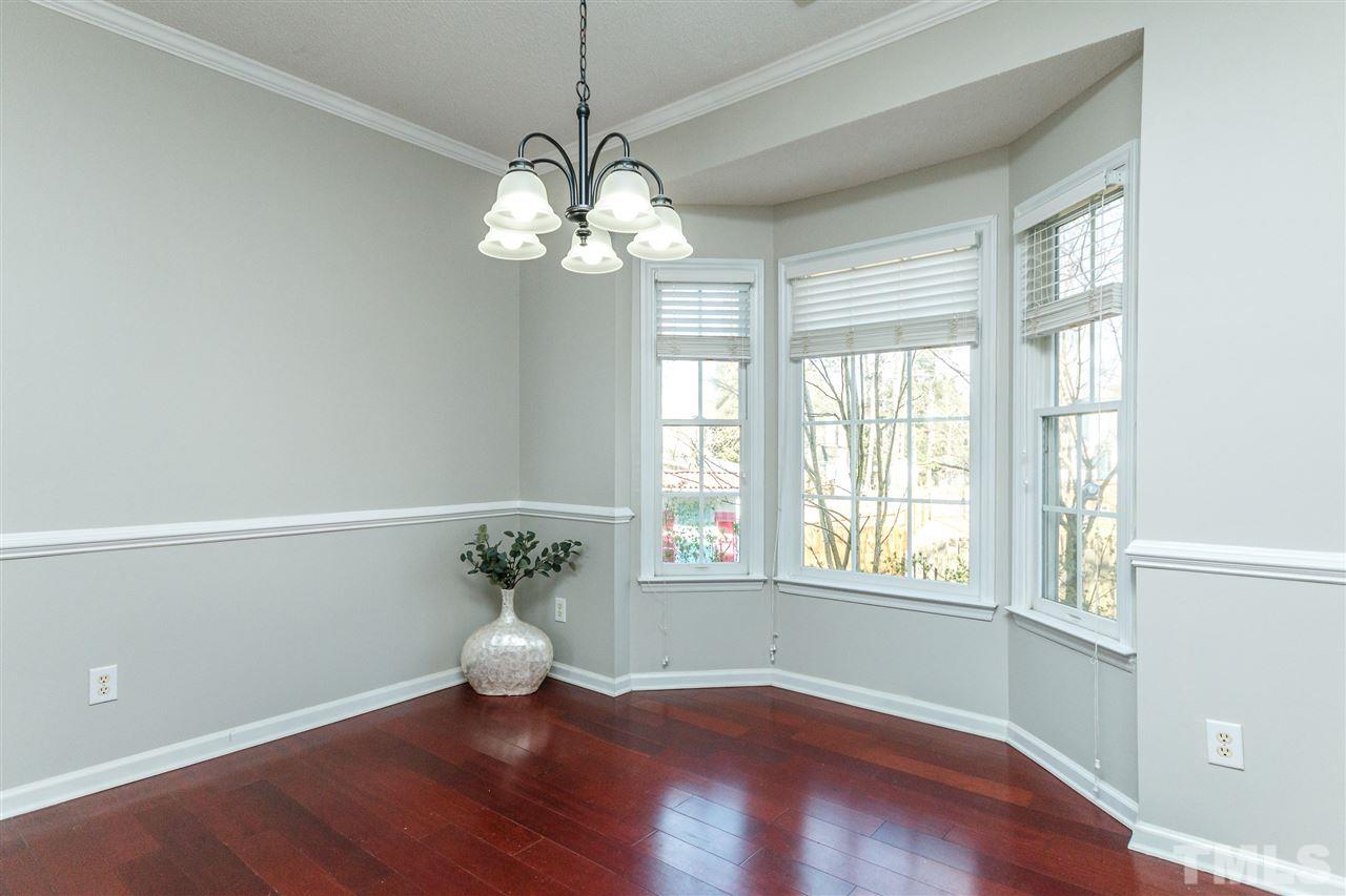 11205 North Radner Way Raleigh, NC 27613 - Photo 6 of 22 a view of an empty room with a window and wooden floor
