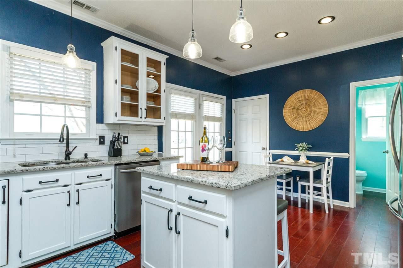 11205 North Radner Way Raleigh, NC 27613 - Photo 10 of 22 a kitchen with a table chairs and a chandelier