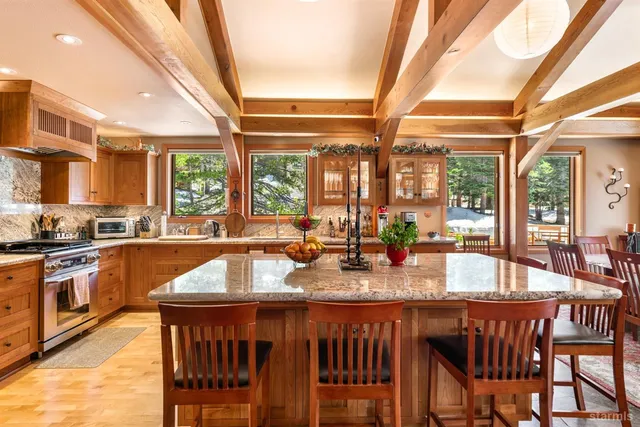 a kitchen with a table chairs and stove