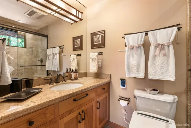 a bathroom with a granite countertop sink a mirror a shower and a bathtub