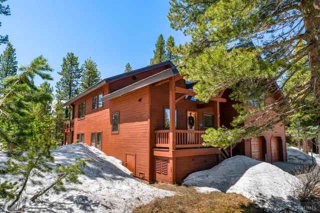 a view of a house with a tree in the background