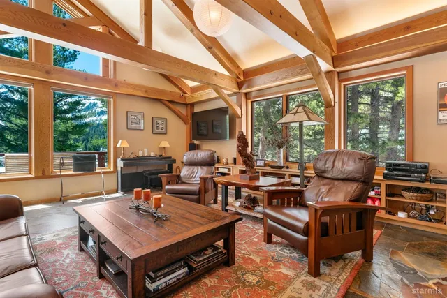 a living room with patio furniture and a large window