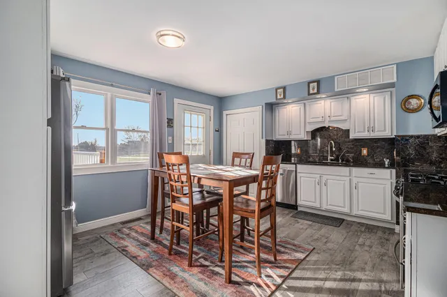 a view of a dining room with furniture and window