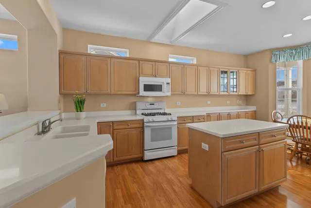 a kitchen with a stove a sink and a microwave