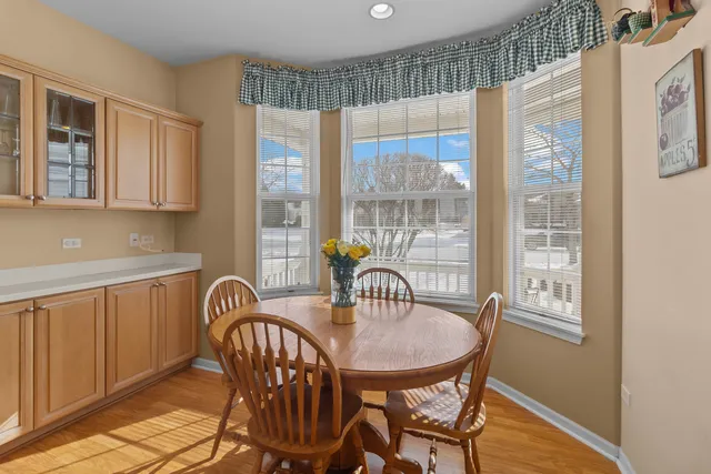 a view of a dining room with furniture a chandelier and wooden floor