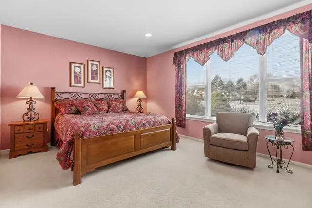 a bedroom with a large bed and a large window