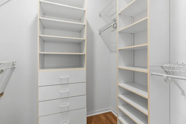 a view of walk in closet with empty racks