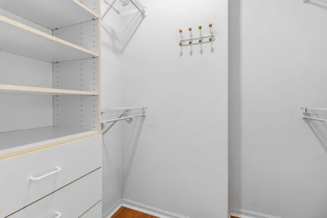 a view of walk in closet with empty racks