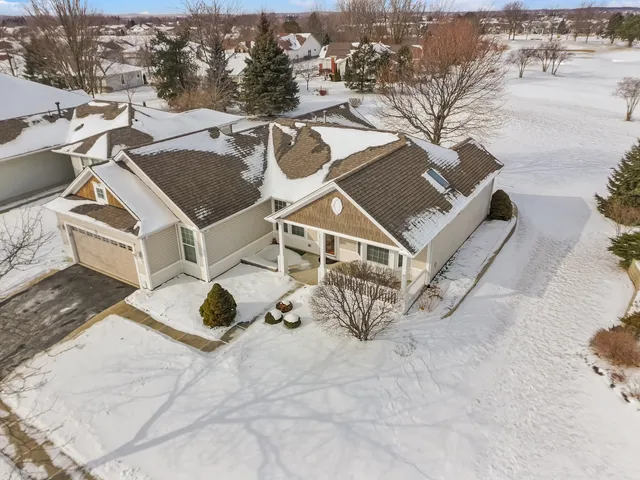 an aerial view of a house with backyard space and parking