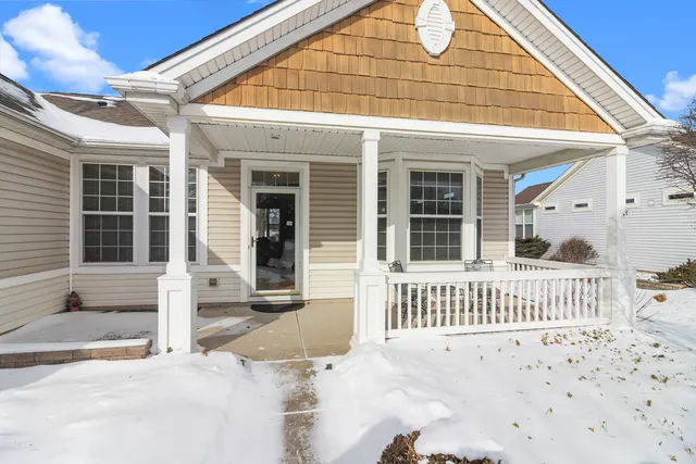 a view of a house with a wooden fence