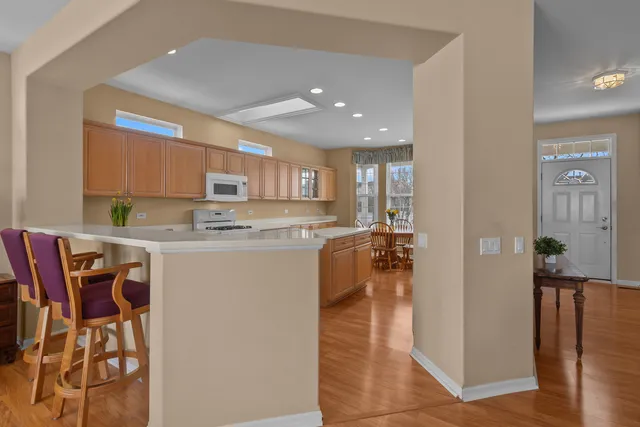 a kitchen with stainless steel appliances granite countertop a refrigerator and a stove top oven