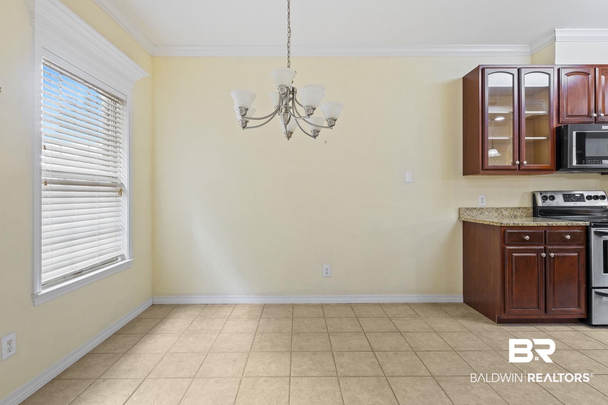 166 Club Drive Fairhope, AL 36532 - Photo 19 of 41 Unfurnished dining area with ornamental molding, a wealth of natural light, and an inviting chandelier