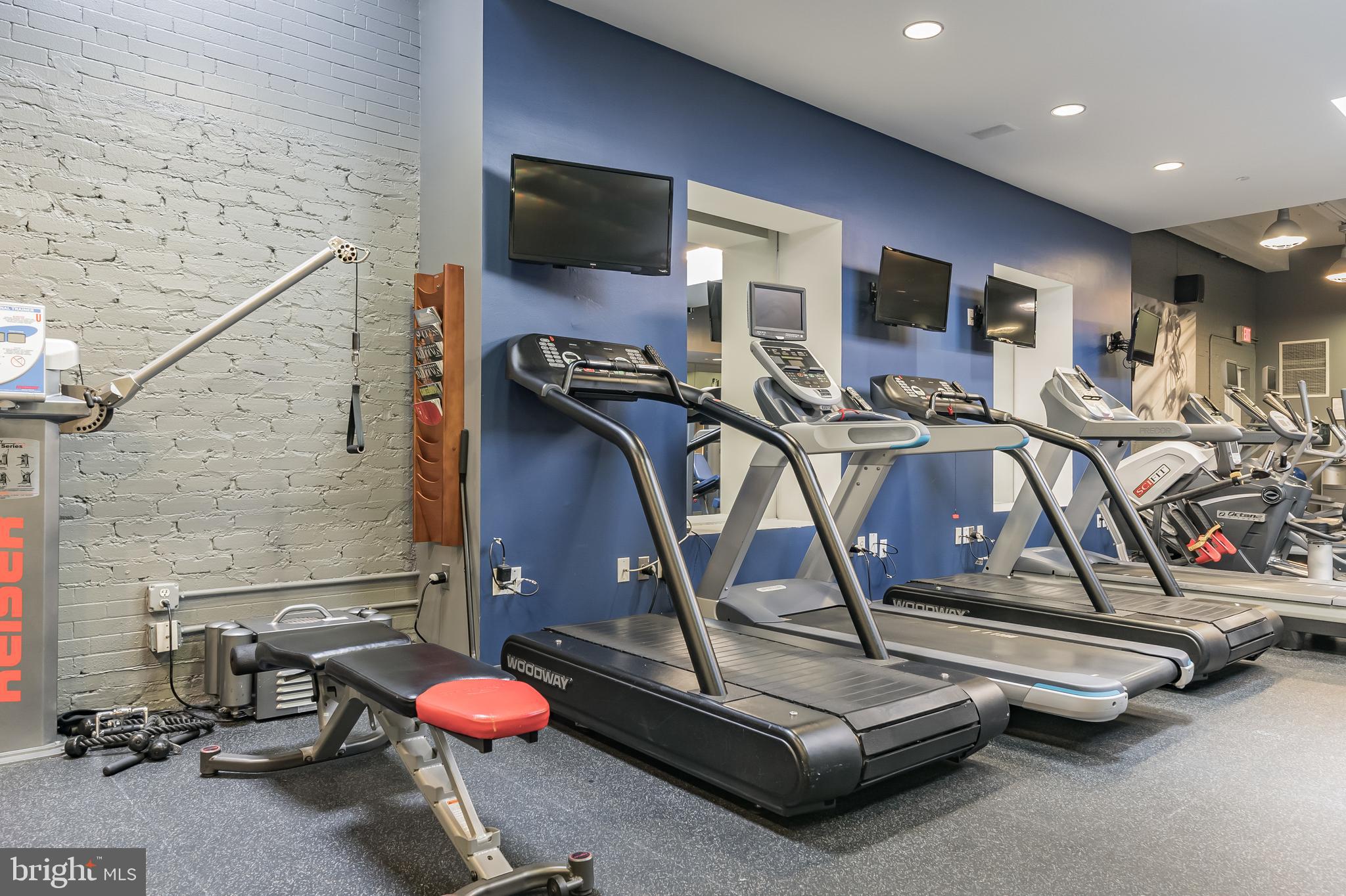 1600 Arch Street, Unit 612 Philadelphia, PA 19103 - Photo 7 of 11 a room with gym equipment and flat screen tv