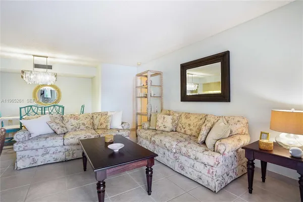 a living room with furniture and a night stand