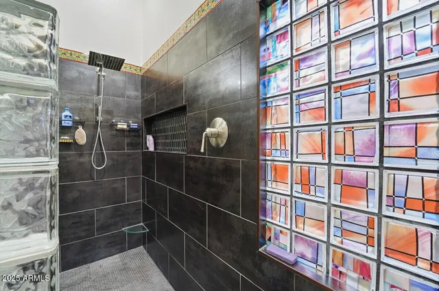 a bathroom with a granite countertop sink a toilet and a mirror