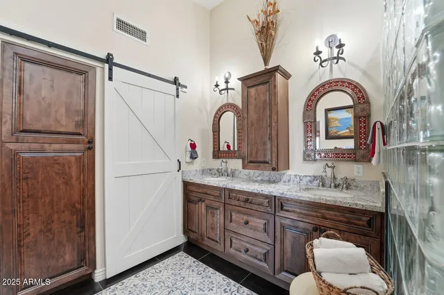 a bedroom with a bed and painting on the wall