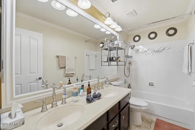 a view of a livingroom with workspace and a window