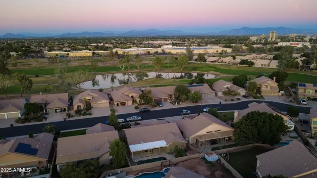 an aerial view of residential house with outdoor space and swimming pool
