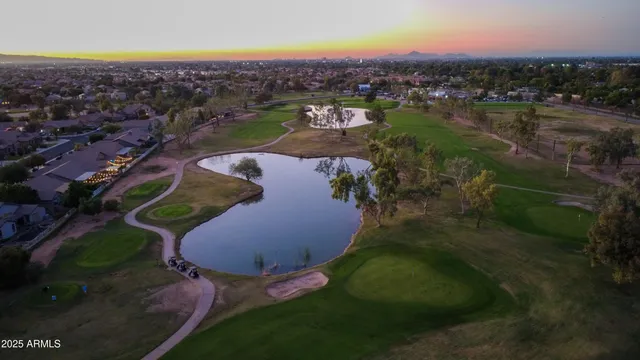 an aerial view of a house with outdoor space tennis court