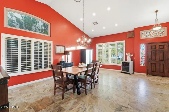 a dining room with furniture a chandelier and window