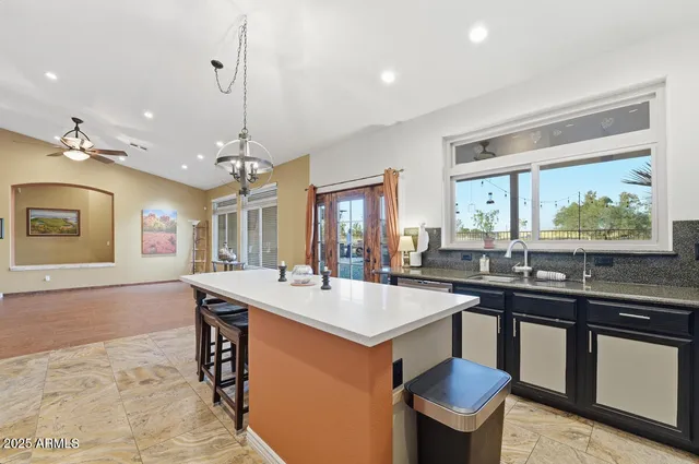 a large kitchen with a table and chairs