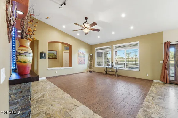 a view of a livingroom with furniture and a flat screen tv