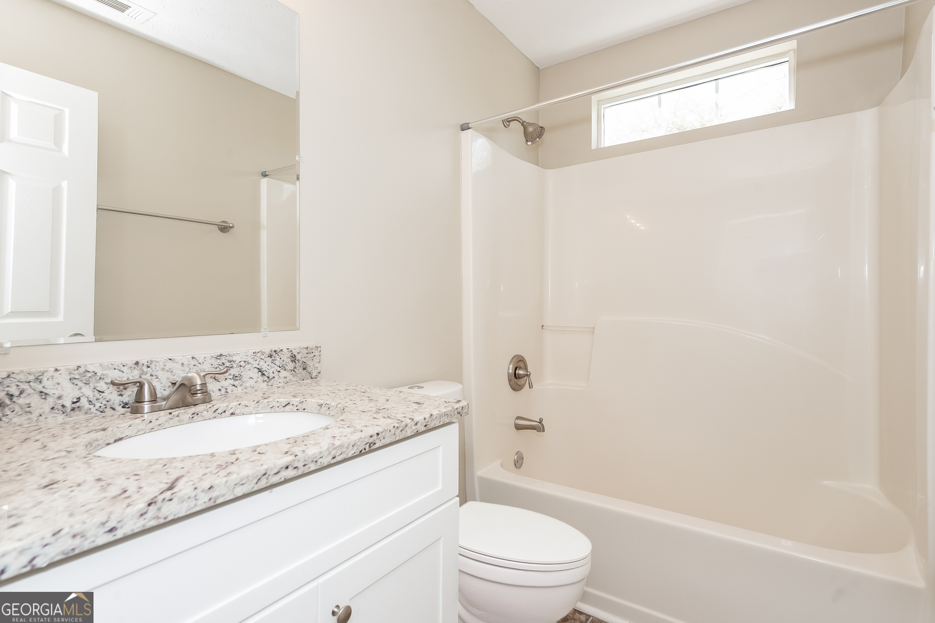 1343 Wimbleton Cove Hampton, GA 30228 - Photo 14 of 17 a bathroom with a granite countertop sink a mirror a shower and a toilet