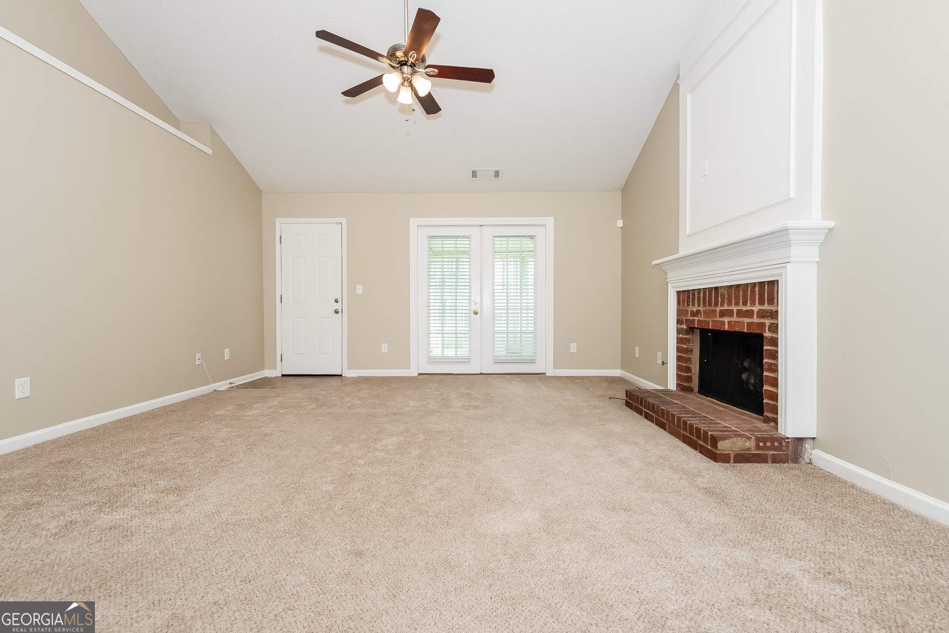1343 Wimbleton Cove Hampton, GA 30228 - Photo 2 of 17 a view of an empty room with a fireplace