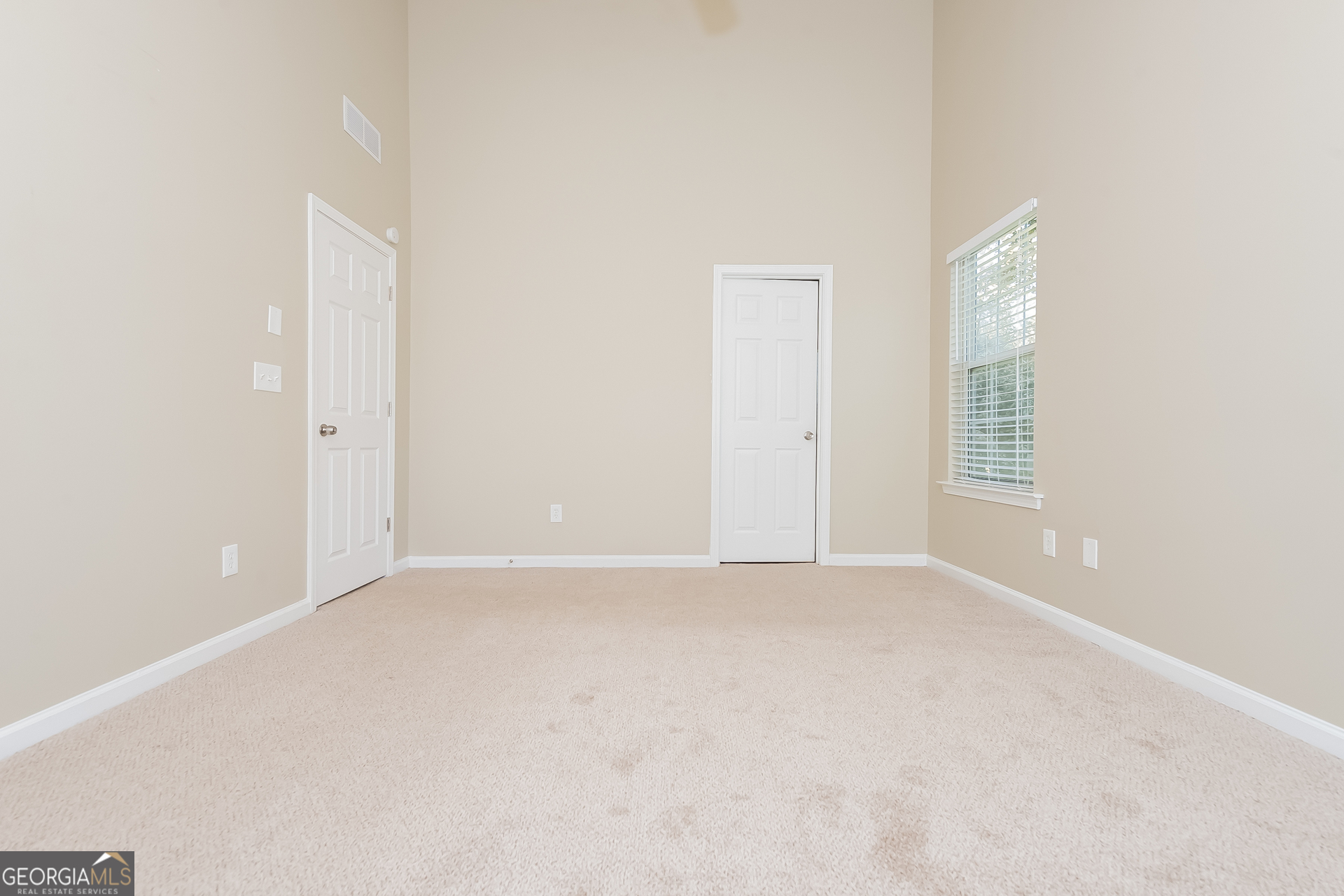 1343 Wimbleton Cove Hampton, GA 30228 - Photo 7 of 17 an empty room with windows and closet