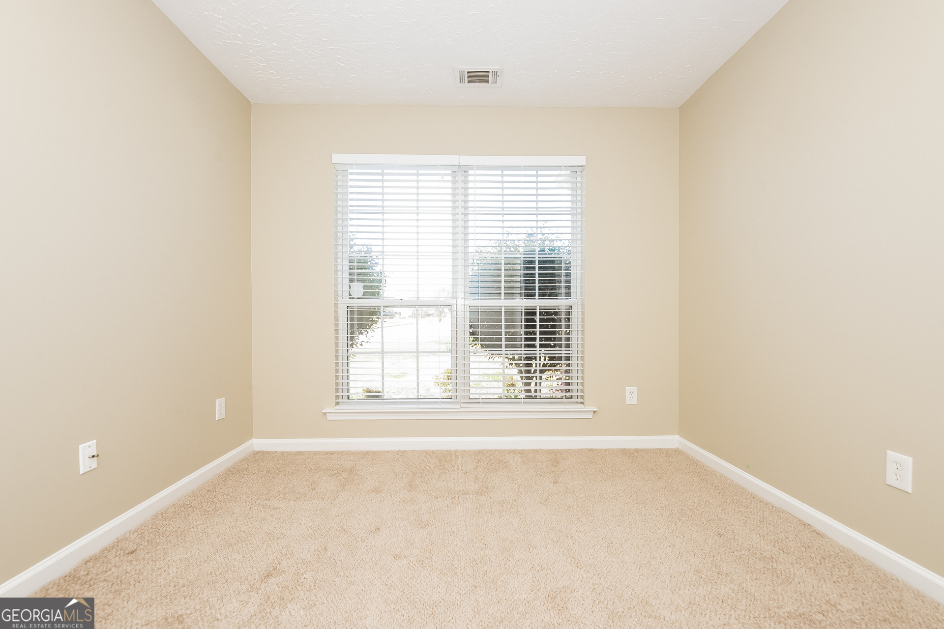 1343 Wimbleton Cove Hampton, GA 30228 - Photo 9 of 17 an empty room with a window