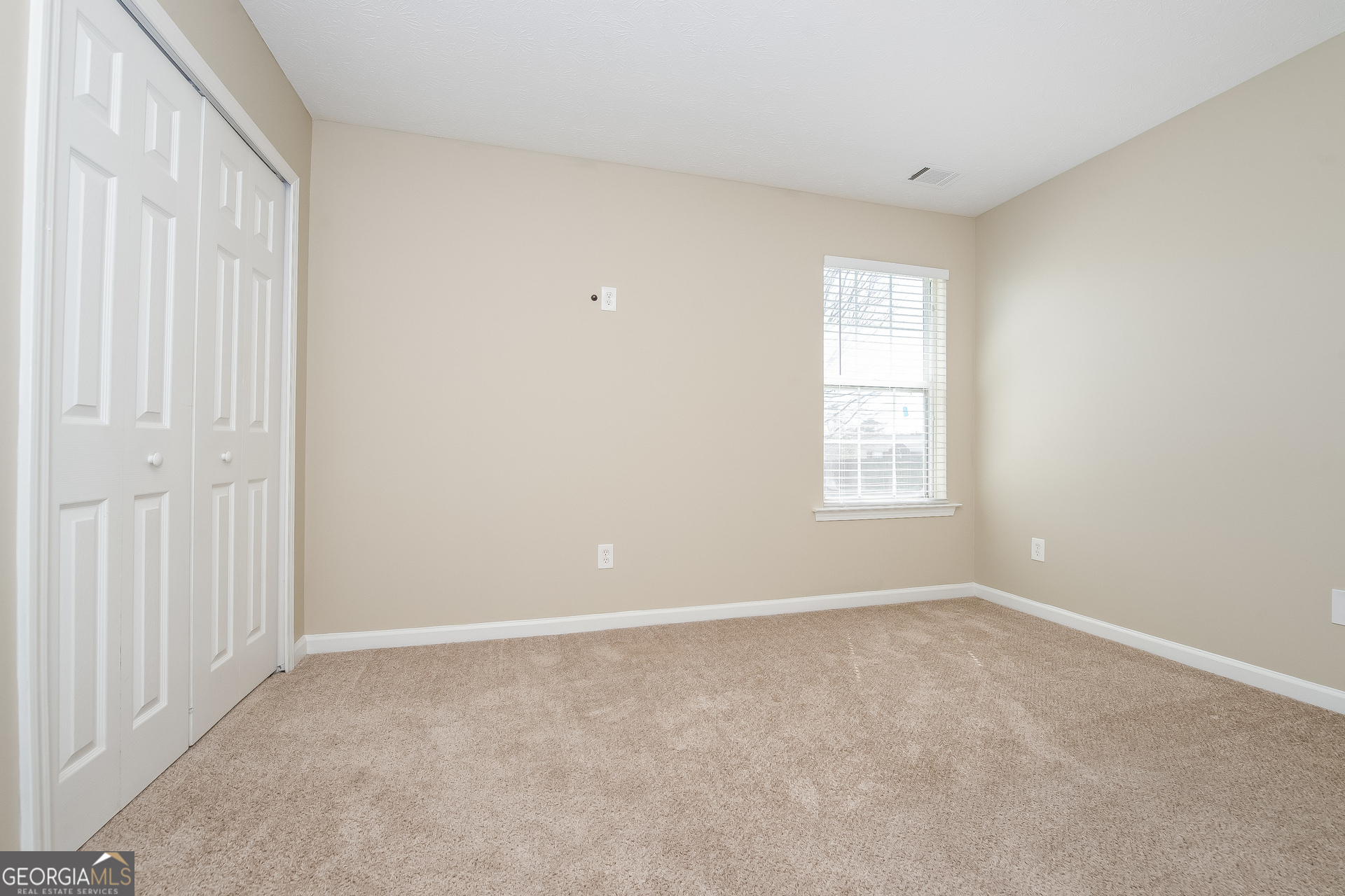 1343 Wimbleton Cove Hampton, GA 30228 - Photo 10 of 17 a view of an empty room with a window