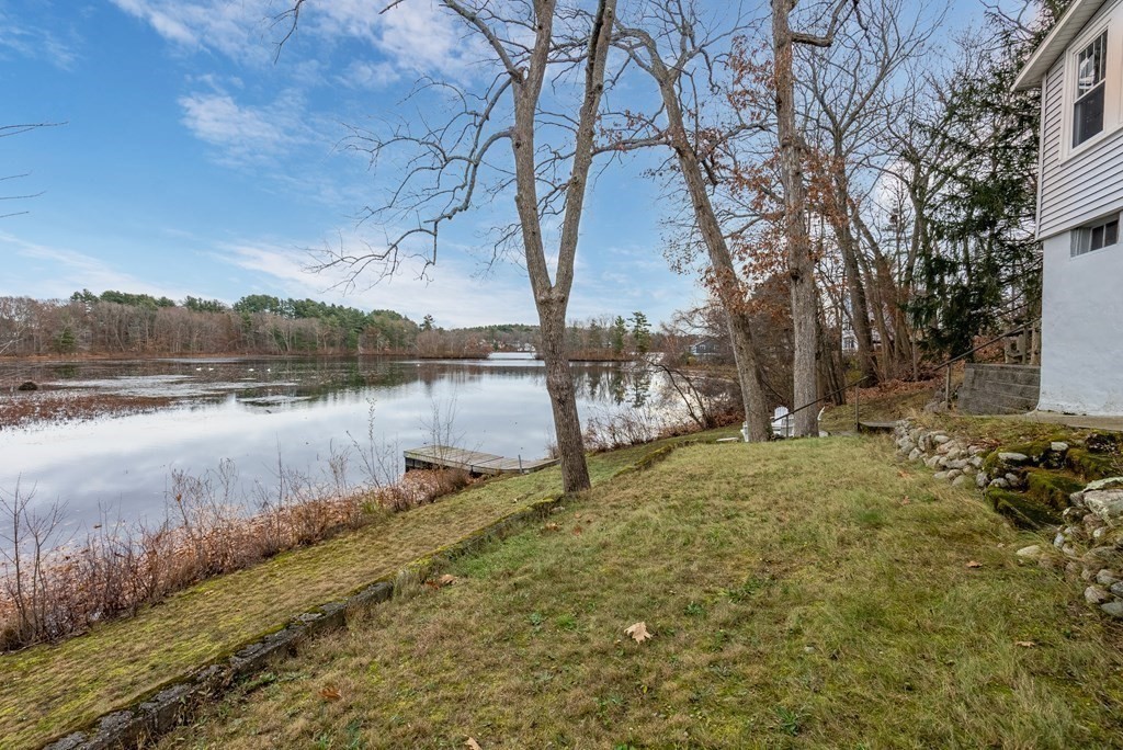 36 Shore Road Wellesley, MA 01760 - Photo 20 of 27 a backyard of a house with lots of green space and lake view