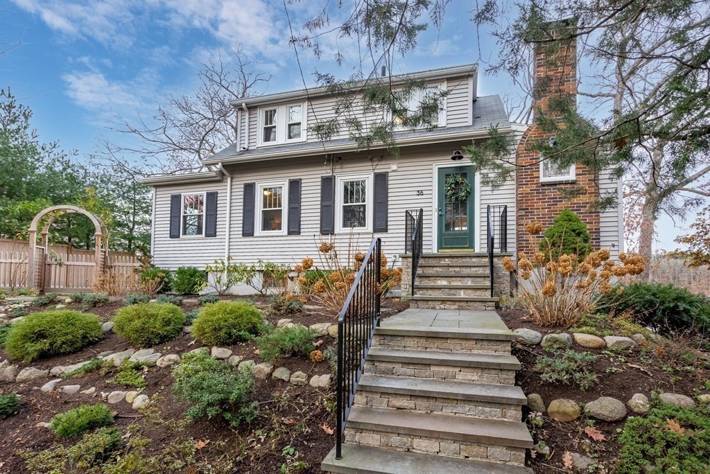 36 Shore Road Wellesley, MA 01760 - Photo 3 of 27 a front view of a house with a garden