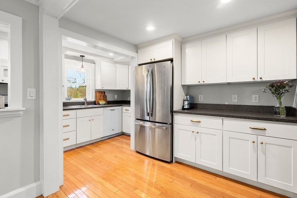 36 Shore Road Wellesley, MA 01760 - Photo 8 of 27 a kitchen with white cabinets and stainless steel appliances