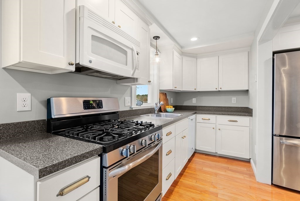 36 Shore Road Wellesley, MA 01760 - Photo 9 of 27 a kitchen with stainless steel appliances granite countertop a stove and a white cabinets