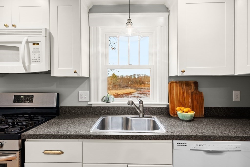 36 Shore Road Wellesley, MA 01760 - Photo 10 of 27 a kitchen with granite countertop a sink stainless steel appliances white cabinets and a granite counter tops